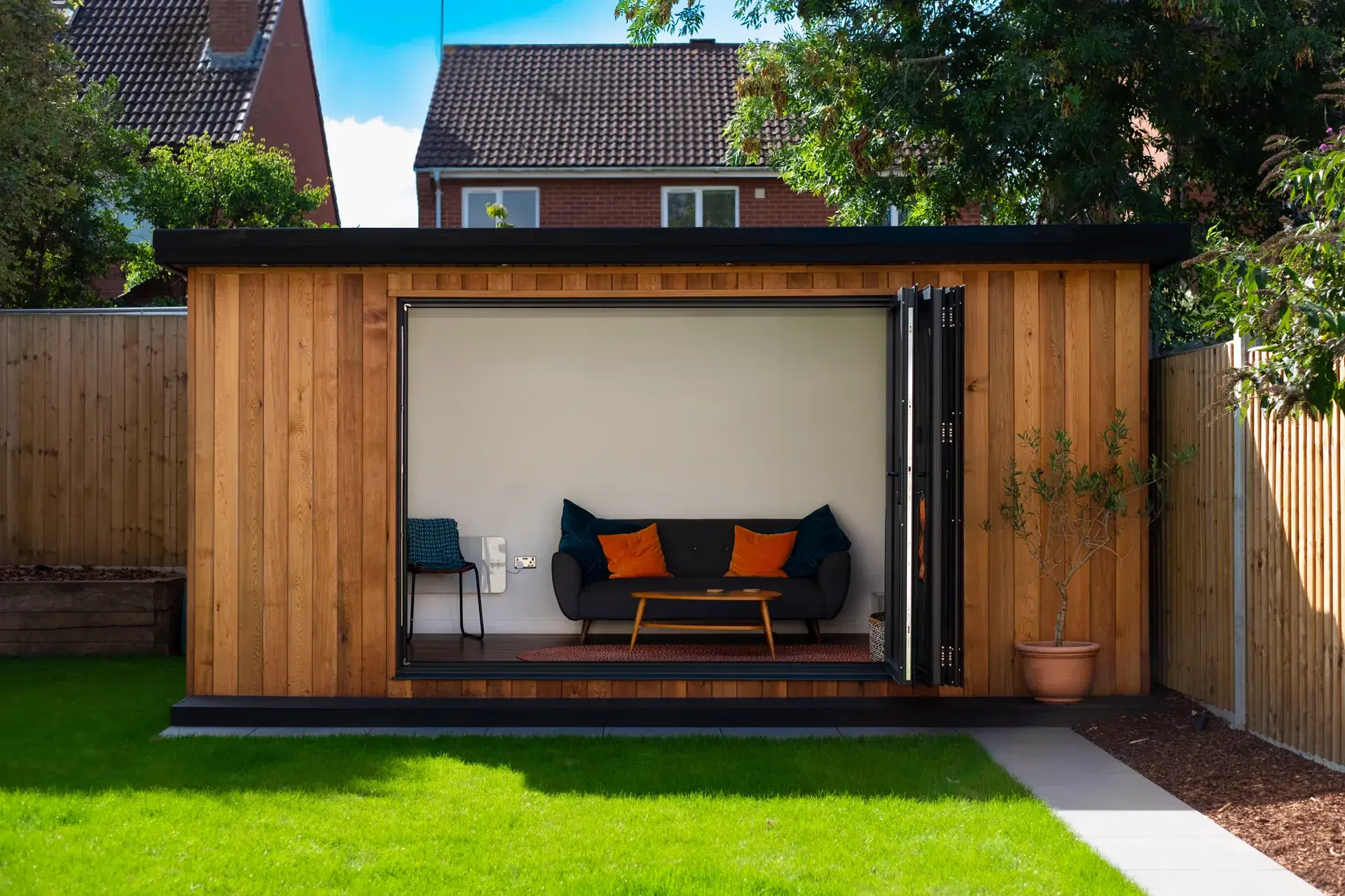 Cedar-clad garden room with bi-fold doors by Kingsley Build Group