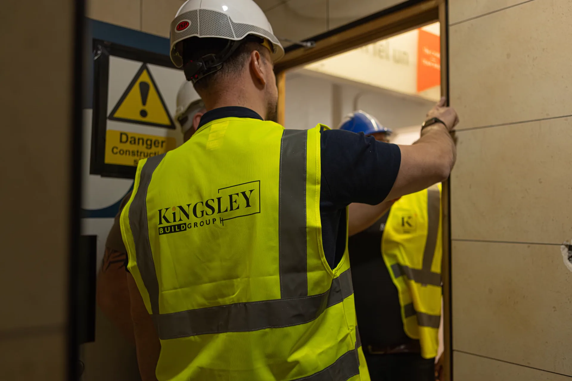Kingsley operative in PPE at a secured doorway