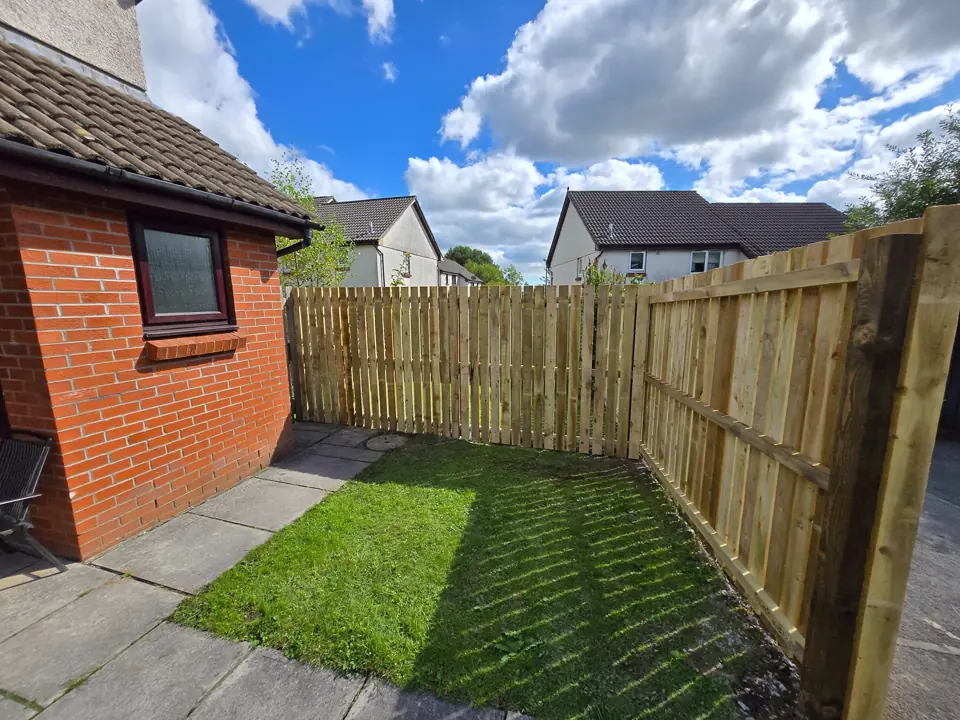 New feather-edge fence and gate to a social-housing garden