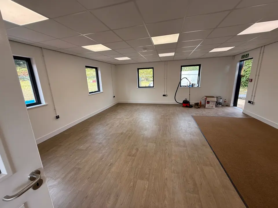 Finished classroom interior with laminate floor and suspended ceiling