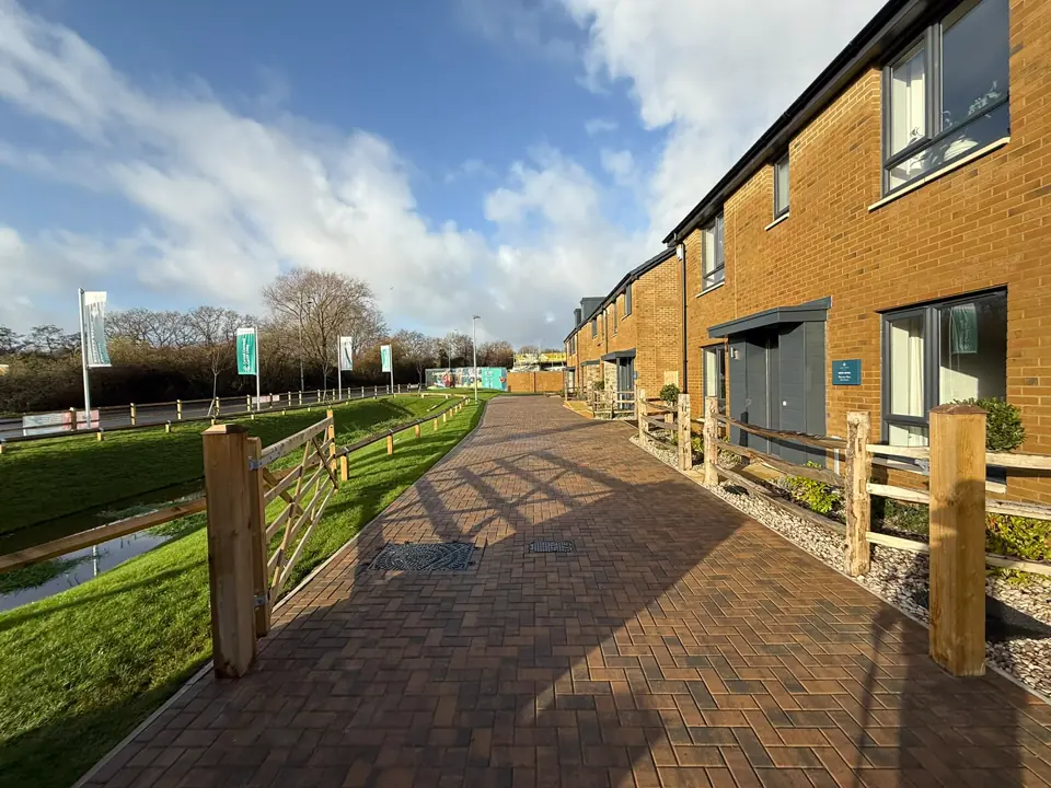 Block-paved path with post-and-rail fencing at a new housing development in Cardiff